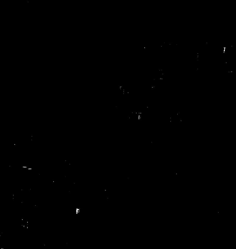 Sparse white pixels on a black field where the model detects manure
